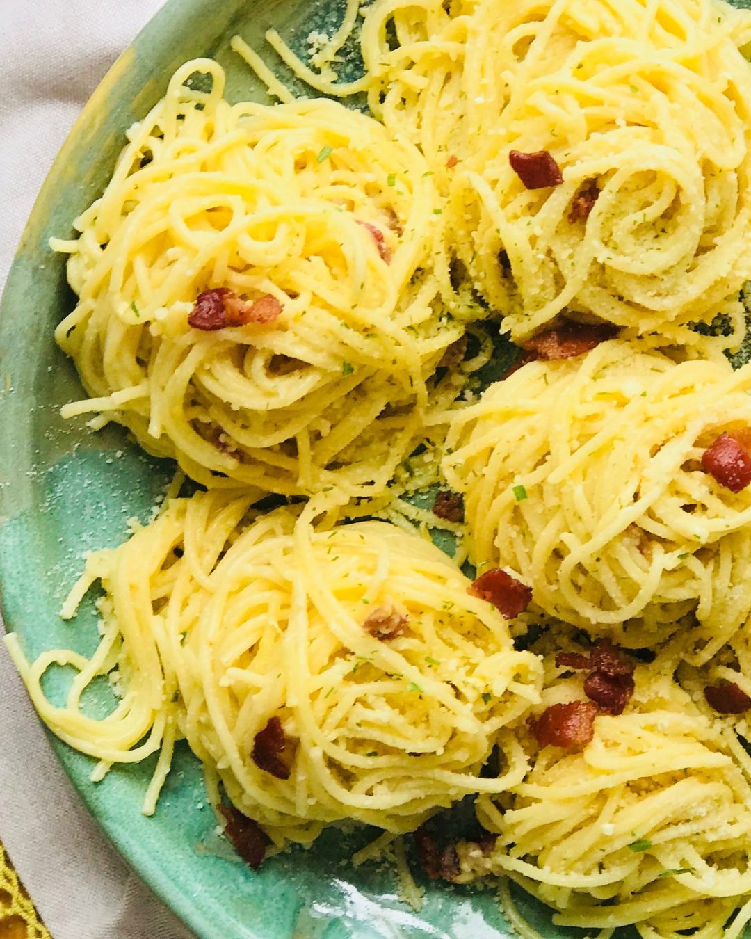 Nests of carbonara on a green glazed plate