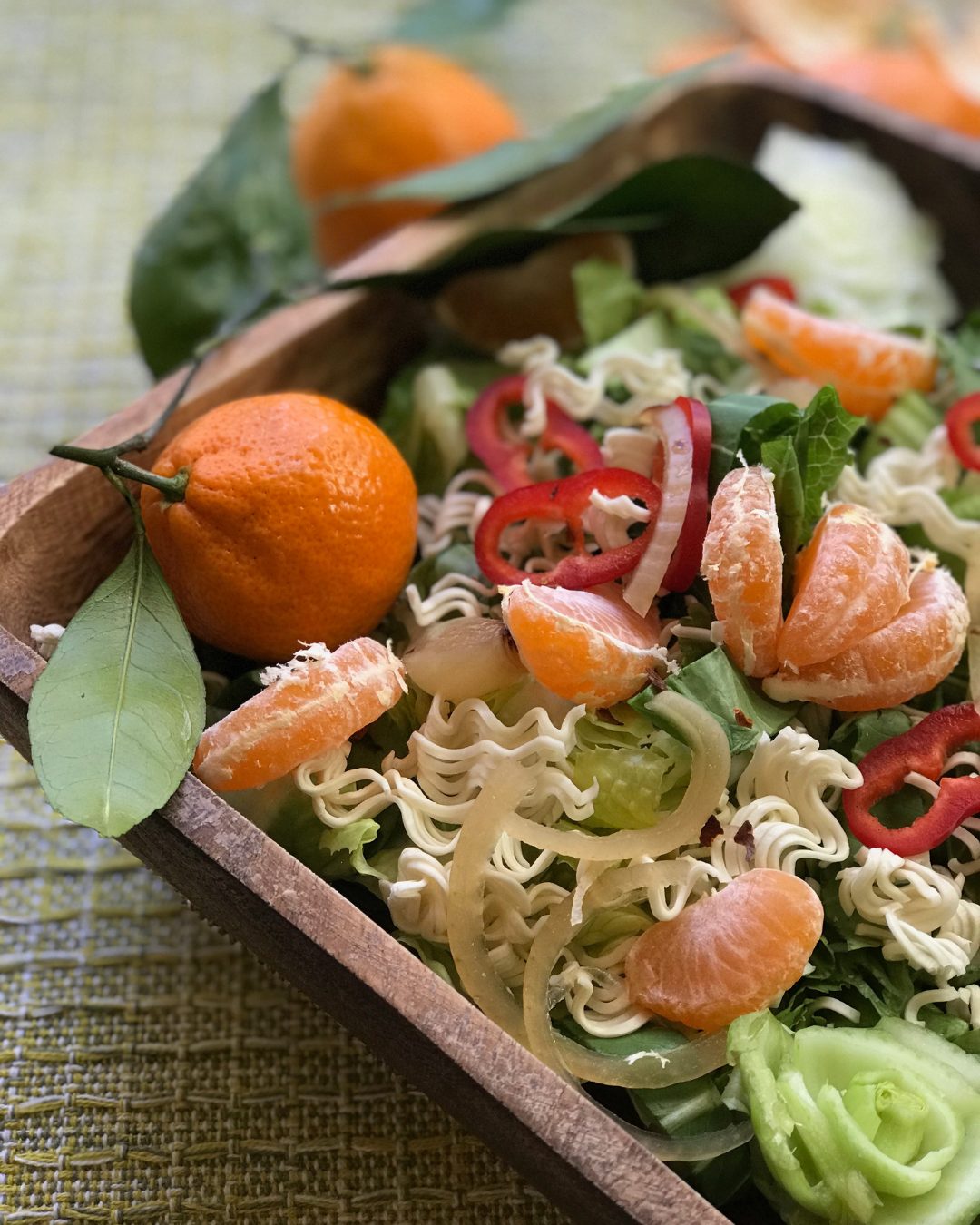Mandarin and ramen salad in a wooden tray