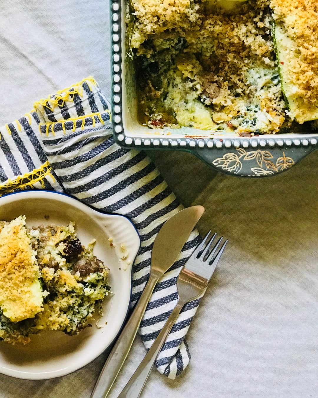 Zucchini and sausage bake with striped napkins